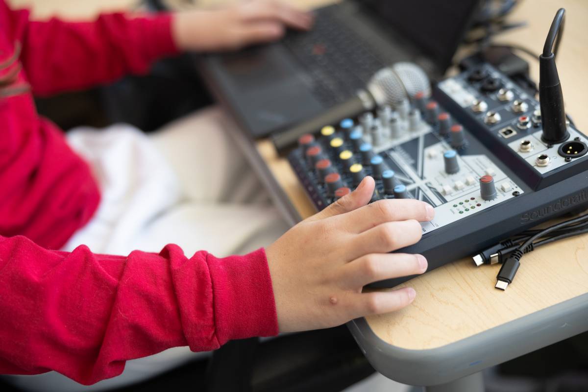 A SNACS student getting hands-on experience working on a soundboard.