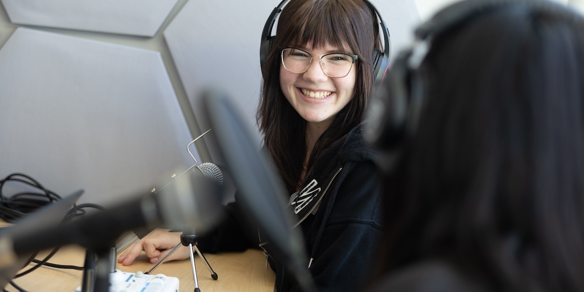 SNACS student wearing headphones in recording studio