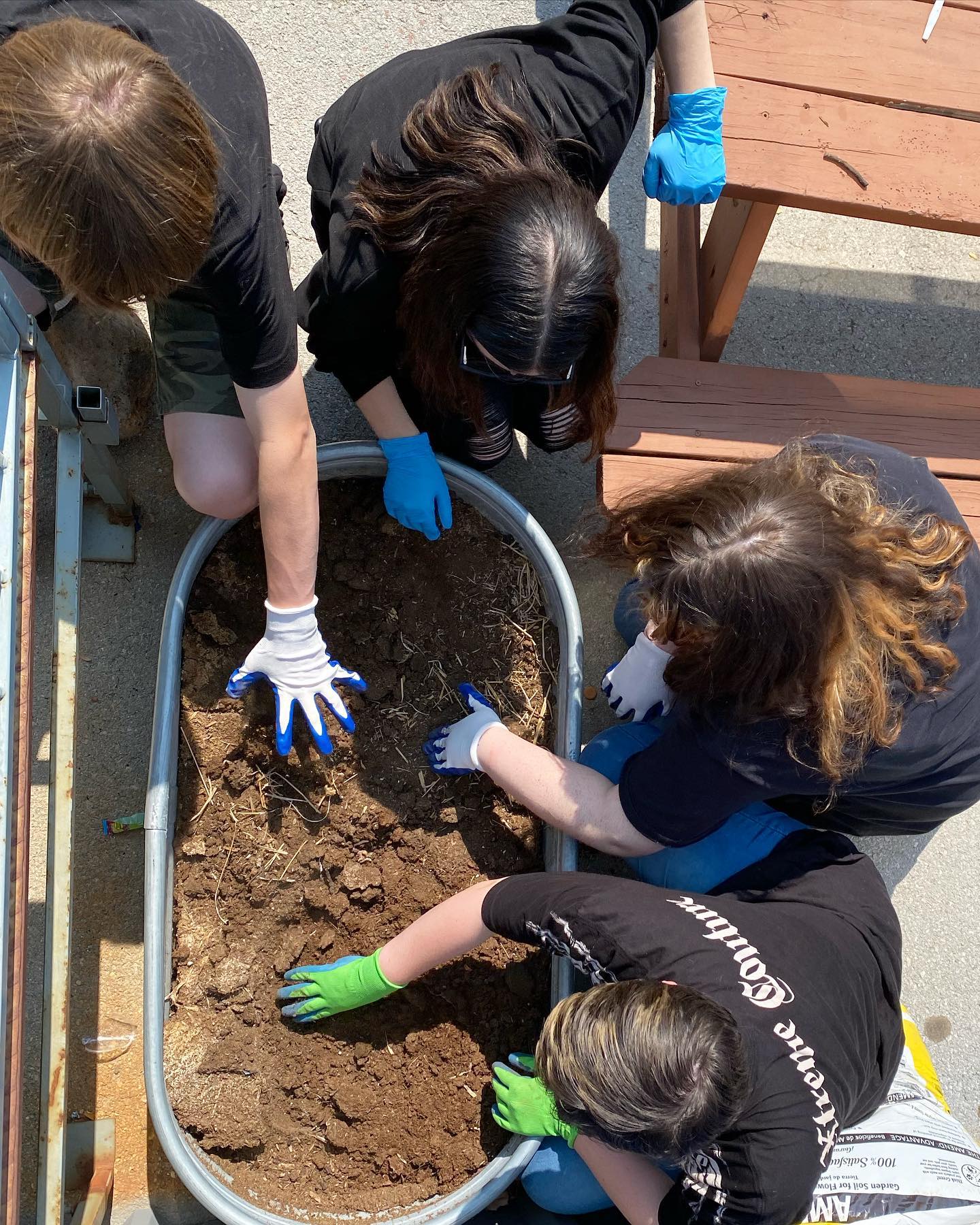 SNACS students digging through soil during one of our messier Expeditionary Learning days!